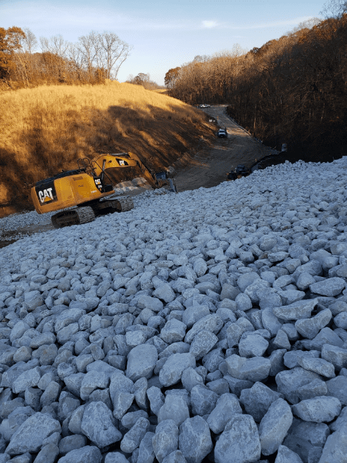 Truck on a hill of rocks.