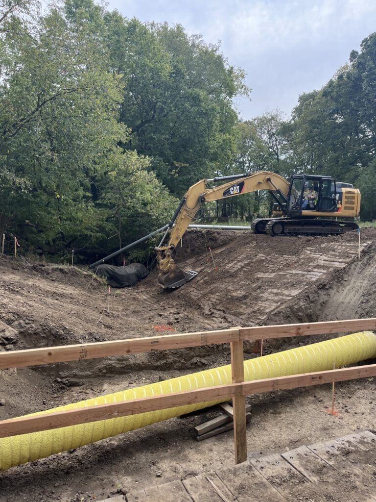 A truck grading a slope.